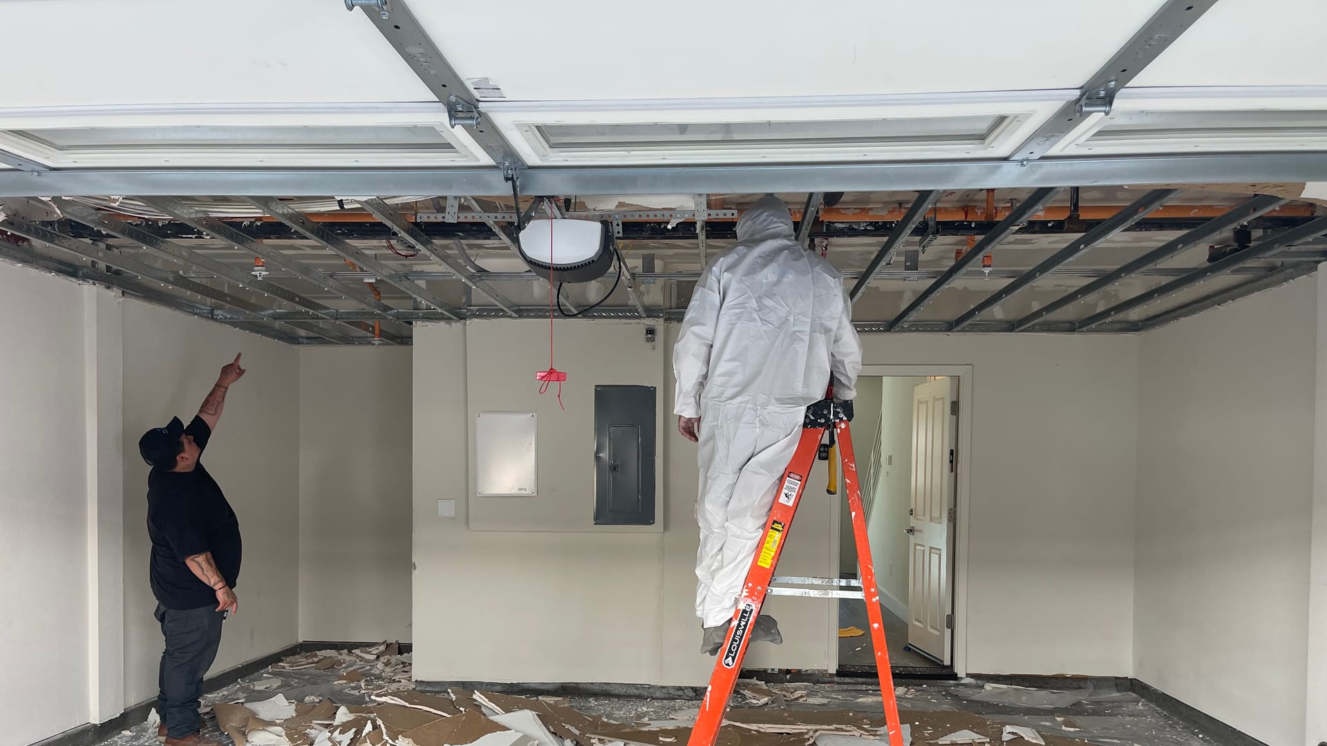 Apex Restoration technician working inside containment